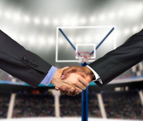 business handshake at basketball court - recruiting fraud concept